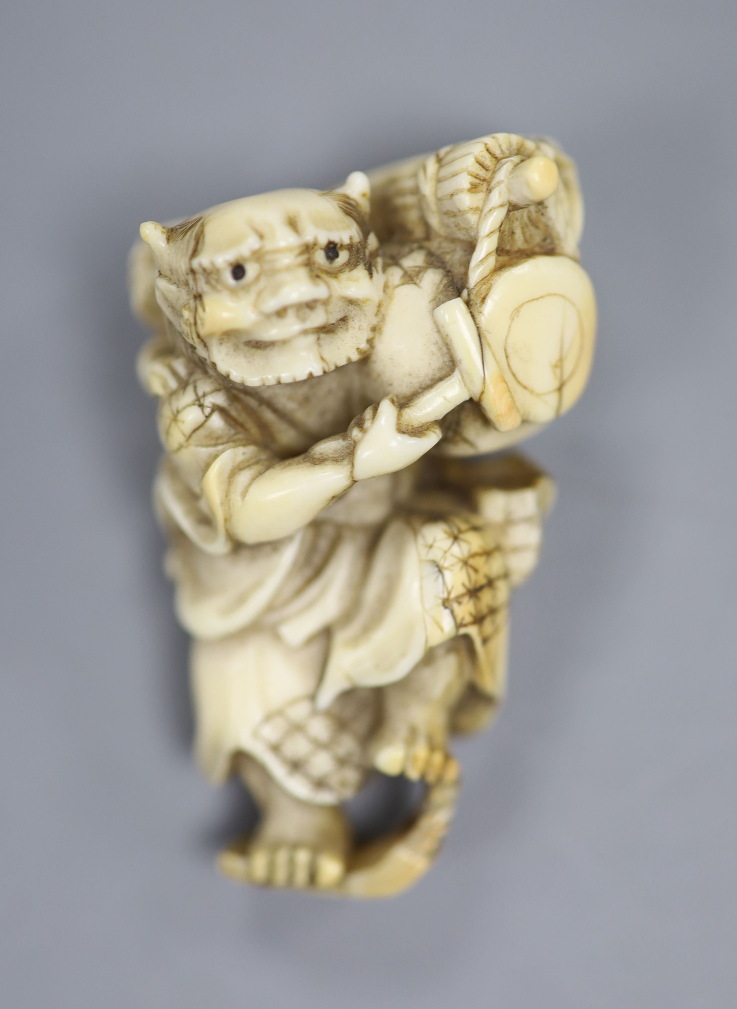 A 19th century Japanese carved ivory okimono of two oni, height 5cm